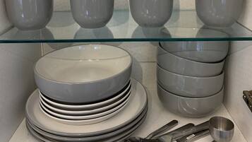 A display of glassware and plates on shelves.