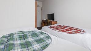 A small, simple room with two beds, a desk, and a television. - Tabist Hotel Yakumo Matsue (Matsue)