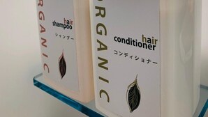 Two bottles of organic hair conditioner on a glass shelf. - WELLSTAY　Osaka　Honmachi　Apartment hotel (Osaka)