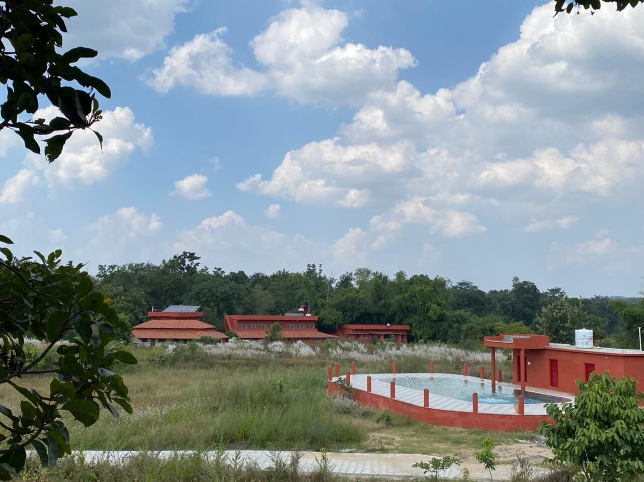 A building with a red roof and a swimming pool.