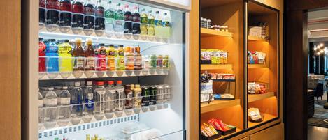 A hotel minibar with a variety of beverages and snacks.