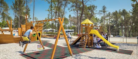 A playground with swings, slides, and climbing structures.