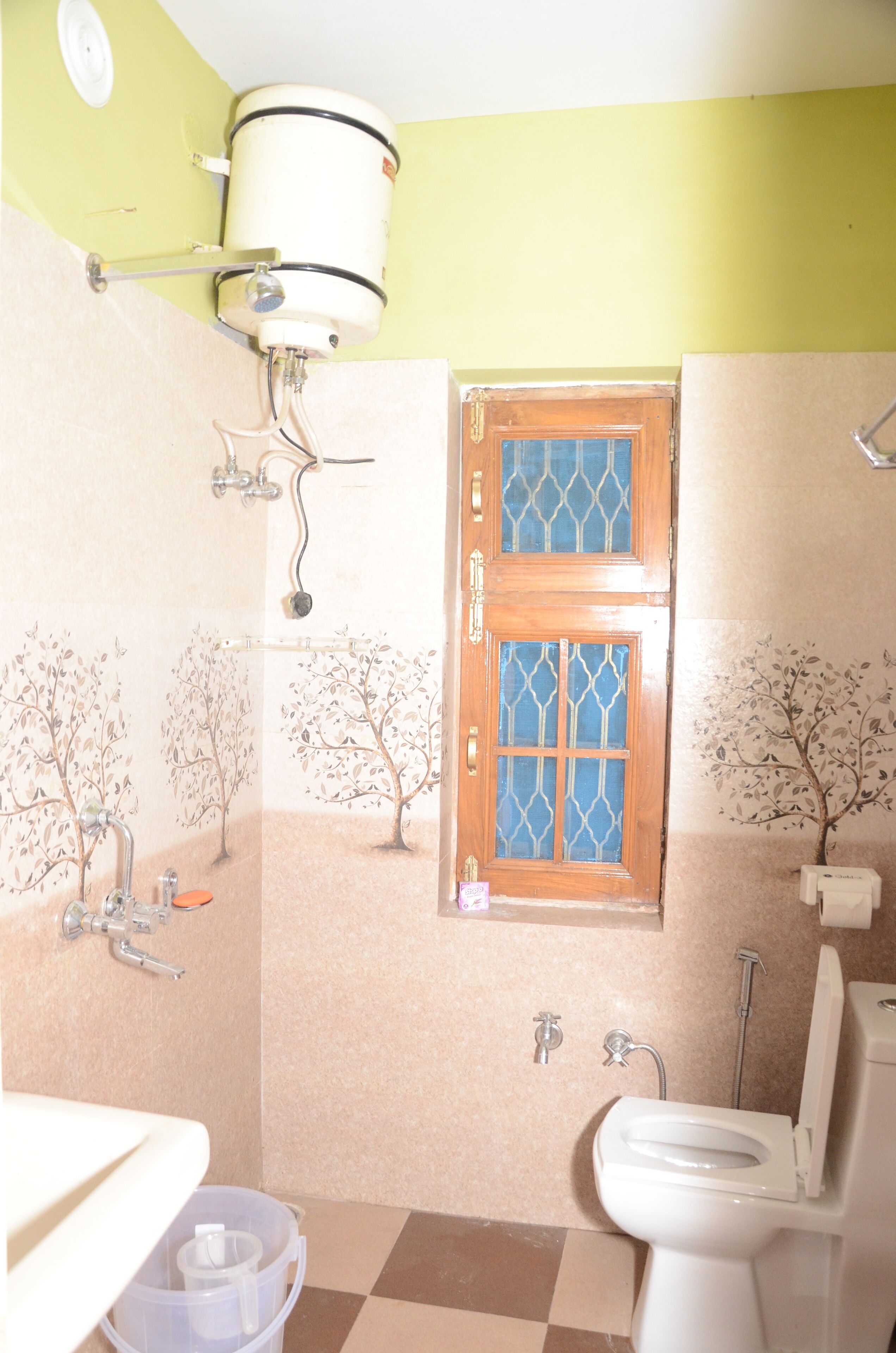 A bathroom with a toilet, sink, and shower.