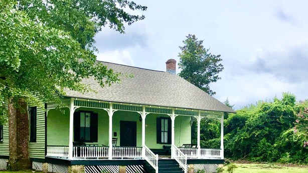 A green house with a porch and a chimney. - In 1840 Burn Cottage (Society Hill)
