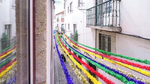 A narrow street with colorful decorations along the sides. - Portuguese Soul Alfama | Terrace & River View | Sleeps 6 (Lisboa)