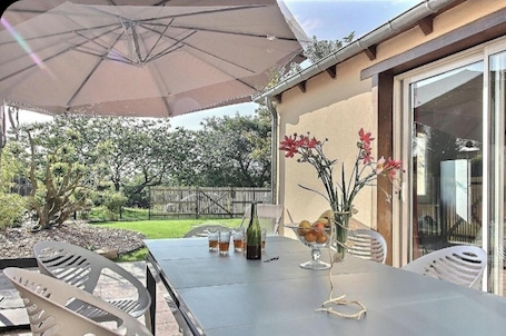 Outdoor dining. Homerez - Charming House in Plourhan with Garden and Terrace