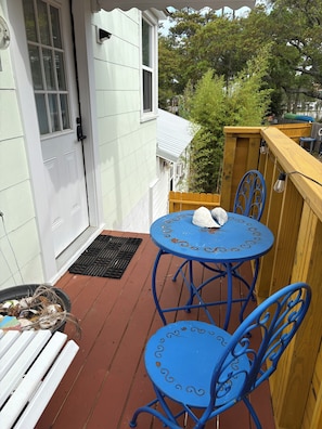 Enjoy a peaceful retreat in this serene outdoor space with a deck, featuring a table and chairs.