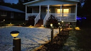 A single-story house with a porch, a front door, and a small front yard. - Beautiful Beach Getaway! Walk to Beach! Sleeps 6. (Oak Island)