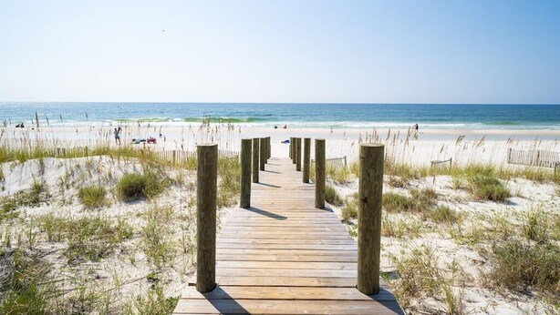 A wooden boardwalk leading to a beach with sand dunes and the ocean in the background. - Short walk to Beach - Pool -Sleeps 8 Wifi (Gulf Shores)