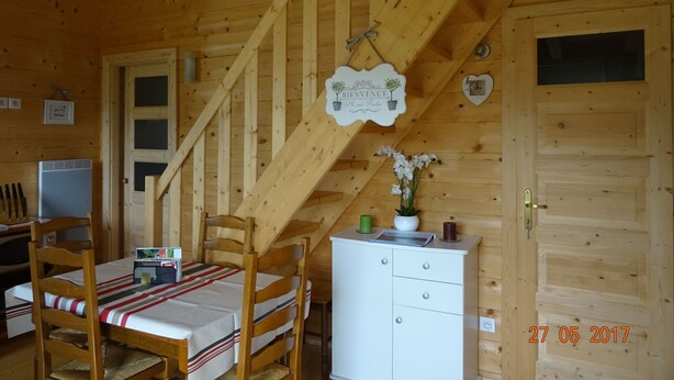 A wooden cabin interior with a bed, a desk, and a staircase. - HOLIDAY IN QUIET AT THE MOUNTAIN (Issor)