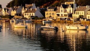 A harbor with boats and houses along the water.