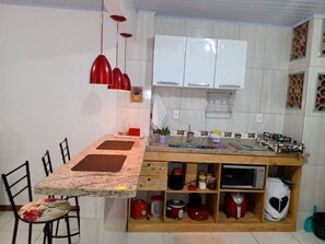 Efficient kitchen with central island dining area and ample storage.