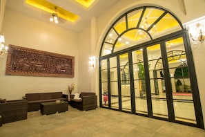 Relax in the spacious lobby with a comfortable seating area and stunning wall art.