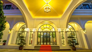 A grand entrance with a red carpet, a chandelier, and potted plants. - Angkor Zhe Jiang Hotel (Siem Reap)