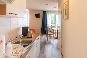 Fridge, microwave, stovetop, coffee/tea maker