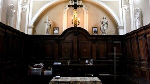 A room with a checkered floor, wooden benches, a table, and a cross at the back. - B&B Il Tulipano - Rogliano (Calabria) Italy (Rogliano)