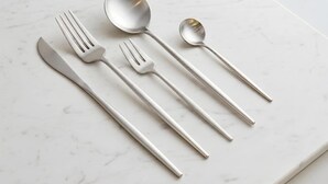 A set of stainless steel cutlery on a marble surface. - ORIGAMINN 303 by b hotel - 5 mins PeacePark (Hiroshima City)