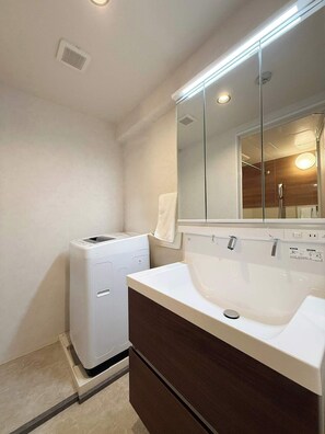 Bathtub, hair dryer, towels, soap