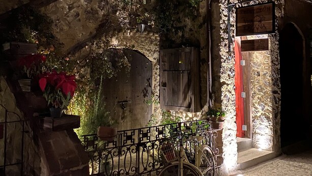 A stone building with a bicycle parked in front.