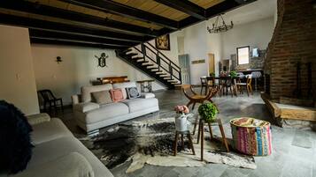 Relax in this inviting living space with a cozy fireplace, dining area, and comfortable seating.