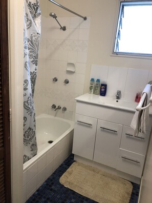 Bathtub, hair dryer, towels, soap