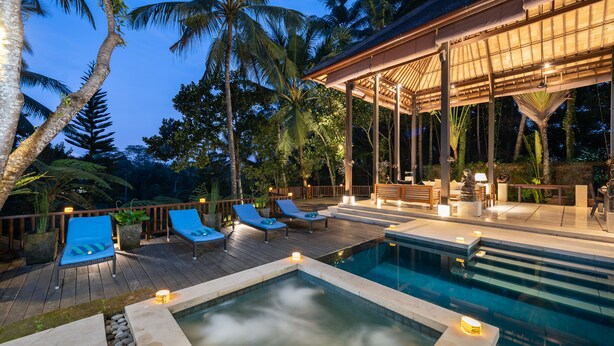 A pool area with lounge chairs, a hot tub, and a covered seating area. - Villa Vajra (Ubud)