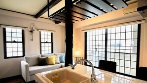 A modern kitchen with a large window, a built-in sink, and a white countertop. - Next to Peace Park, Convenient Central Stay P61 (Hiroshima City)