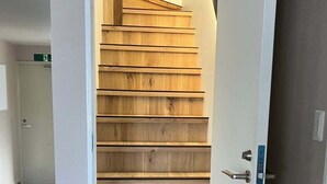 Una escalera de madera con un marco blanco y un picaporte.