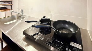 A kitchen with a stainless steel countertop, a built-in stove, a sink, and a range hood. - ORIGAMINN 501 by b hotel -  5 mins PeacePark (Hiroshima City)