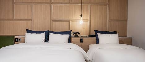 A hotel room with two beds, wooden paneling on the walls, a hanging light fixture, and a telephone on the nightstand.