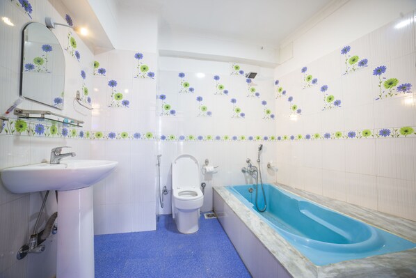 Une salle de bain avec un lavabo, des toilettes et une baignoire.