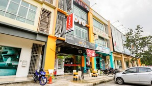 A hotel with a 'HOTEL REST & GO' sign, outdoor seating, and a visible vending machine.