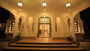 A grand entrance with a central archway, flanked by two symmetrical structures, and a staircase leading up to it. - Rangmahal Pushkar by DIV Hospitality (Pushkar)