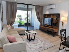 Superior Apartment, 2 Bedrooms | Living area | 50-inch flat-screen TV with cable channels, TV