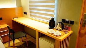 A compact kitchenette with a wooden countertop, a small refrigerator, a kettle, and a coffee maker. - Mayfair Resort (Panglao)