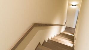 Un escalier avec des marches en bois et un luminaire au sommet.