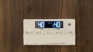 A digital thermostat displaying a temperature of 40 degrees Celsius.