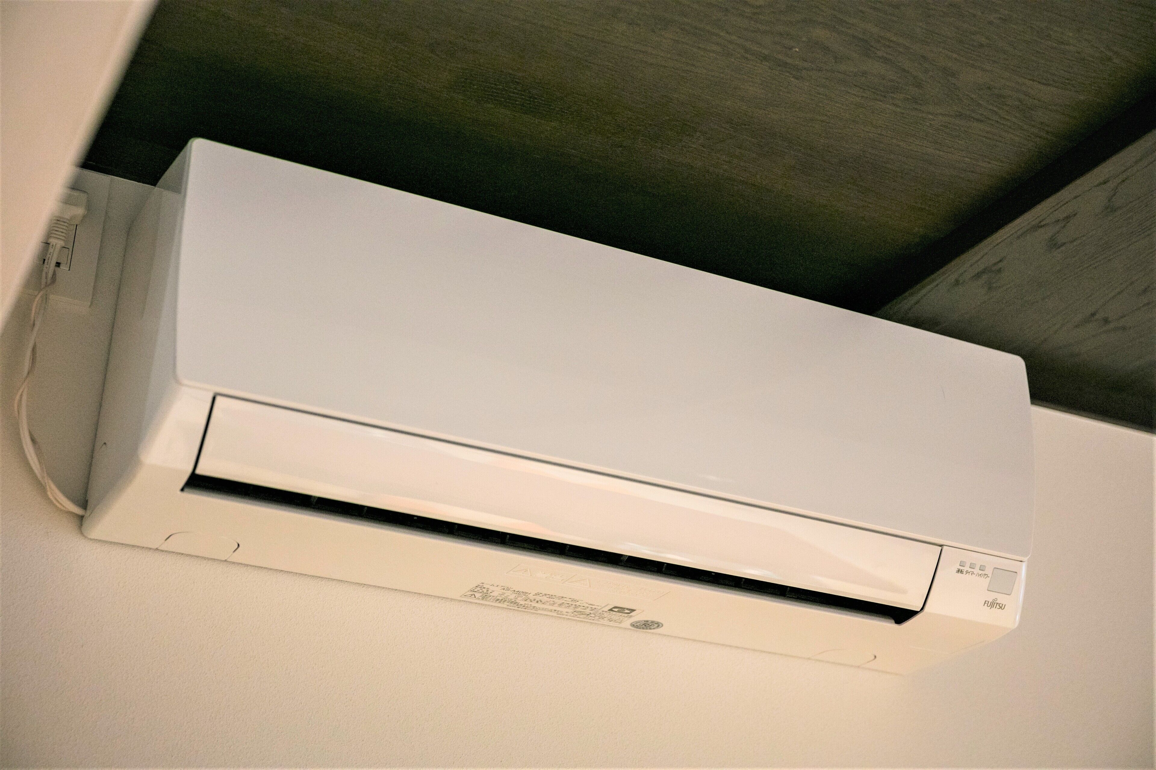 A white air conditioning unit mounted on a wall.