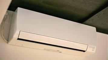 A white air conditioning unit mounted on a wall.