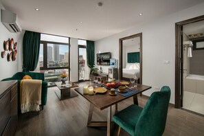Suite de lujo, 1 habitación, balcón, vistas a la ciudad | Zona de estar | Smart TV de 49 pulgadas con canales por cable, una televisión