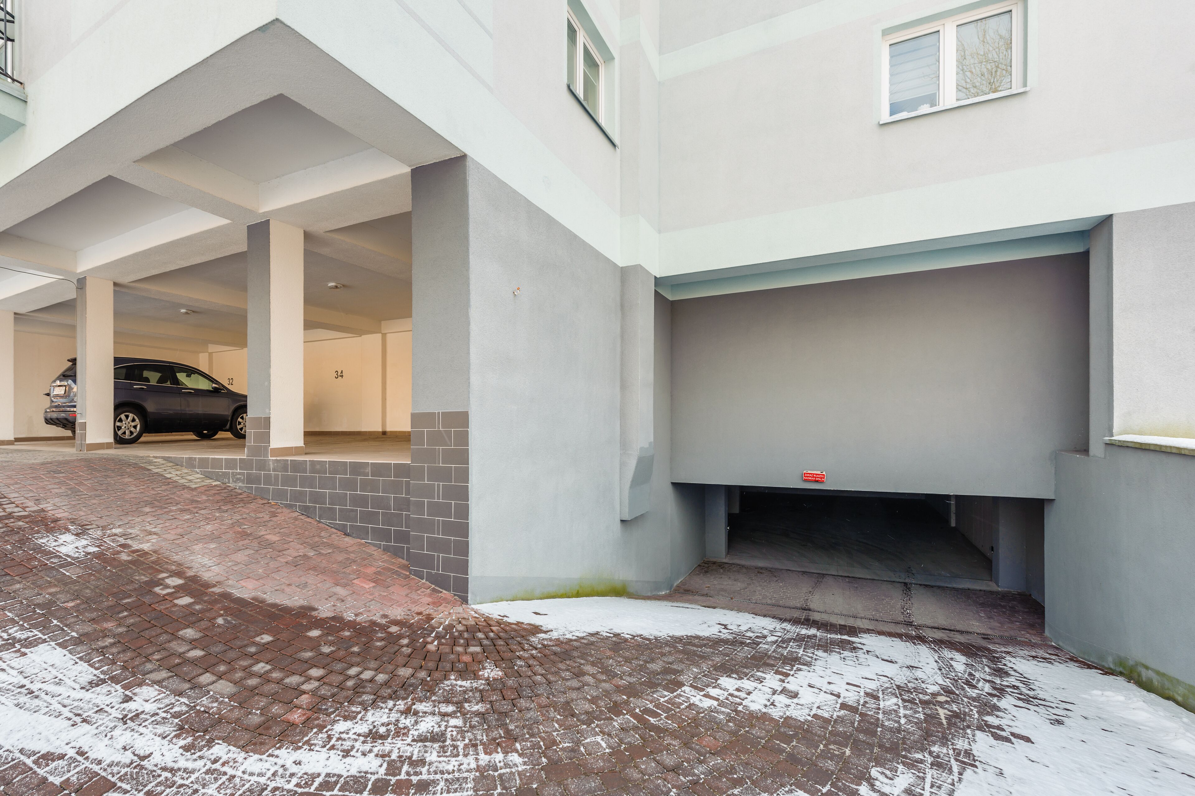 A parking garage with a car parked in one of the spaces.
