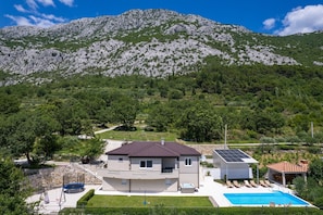 A modern two-story house with a swimming pool, solar panels, and a view of a mountainous landscape. - VILLA BEYBE with Jacuzzi, a private 50sqm pool, Billiard, free WIFI, 3 bedrooms (Gata)