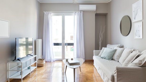 A modern living room with a sofa, TV, and a small table. - UPSTREET Urban Chic 1BD Apartment- Hilton area (Athens)