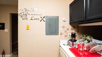 A kitchen with a wall decal stating 'This Kitchen is seasoned with Love.'