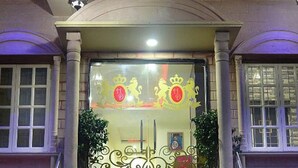 A hotel entrance with a grand staircase, a sign above the door, and decorative elements. - Hotel Dior Near Jal Mahal, Jaipur (Jaipur)