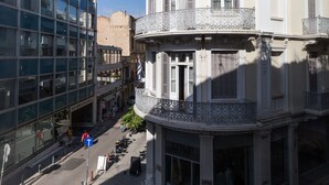 A multi-story building with a classical architectural style, featuring balconies and large windows. - UPSTREET Luxury Apartments in Plaka (Athens)