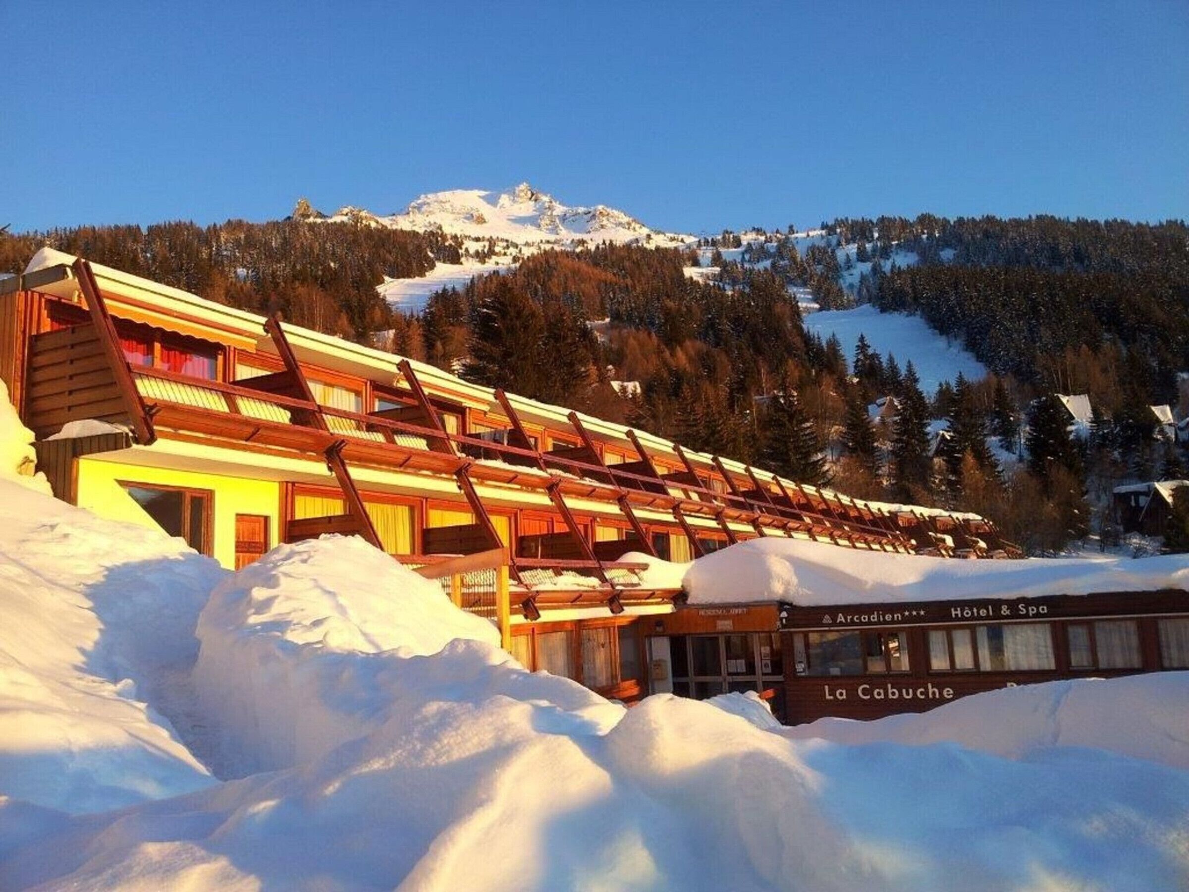 A hotel with a sloped roof and a sign indicating it's a hotel and spa.
