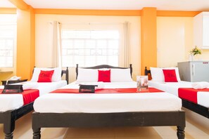 A hotel room with two beds, each with white bedding and red accents, a large window with curtains, and a refrigerator in the corner. - RedDoorz Premium @ Gabinete Road Palawan (Puerto Princesa)