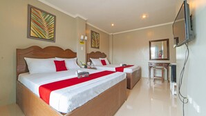 A hotel room with two beds, a TV, and a desk with a chair. - Reddoorz @ Old Buswang Road (Kalibo)