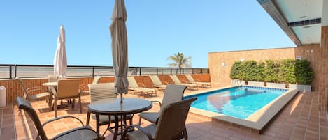 Outdoor pool, open 8:00 AM to 11:00 PM, pool umbrellas, pool loungers